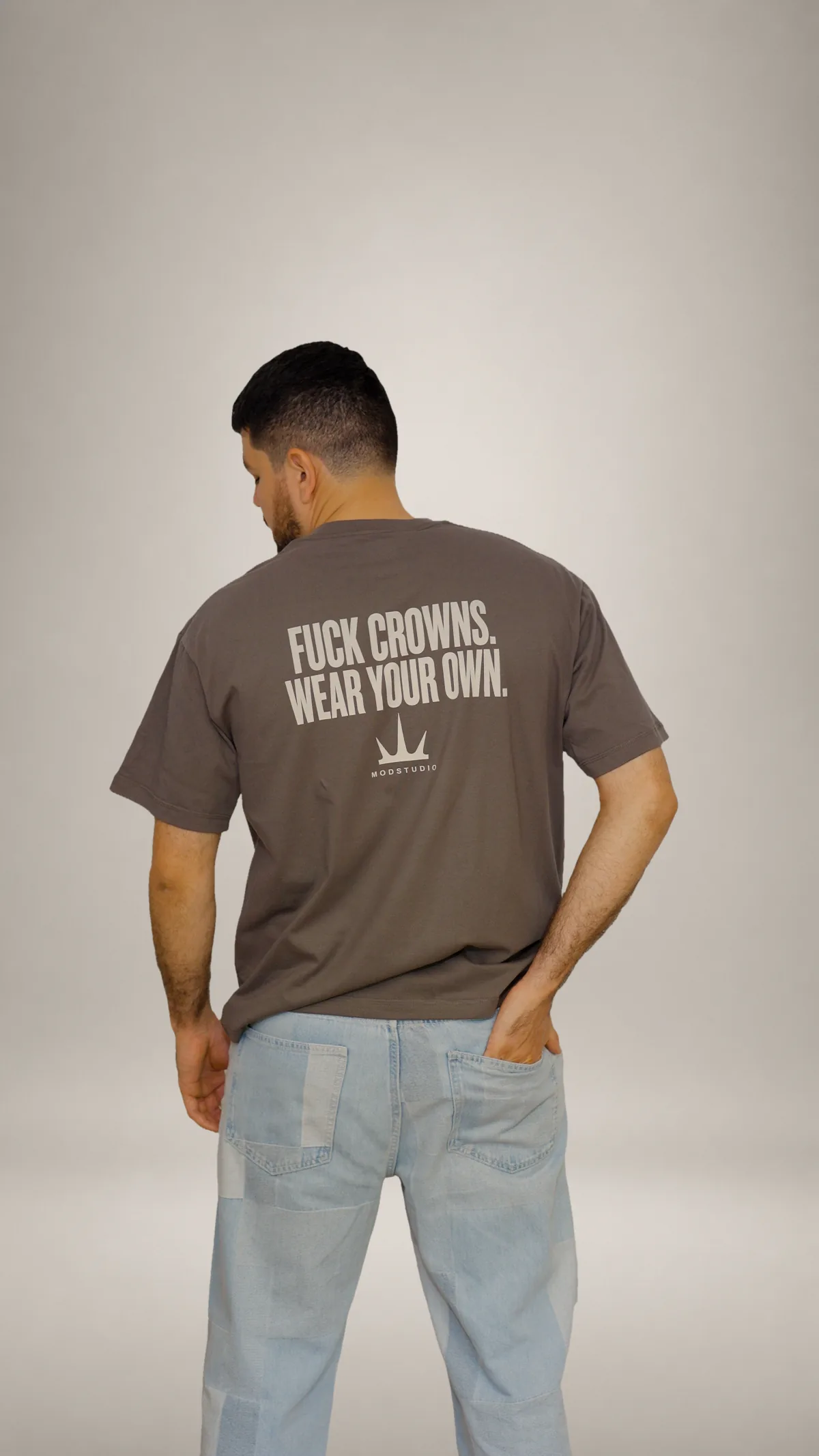 Modelo con F**K CROWNS mostrando el mensaje trasero